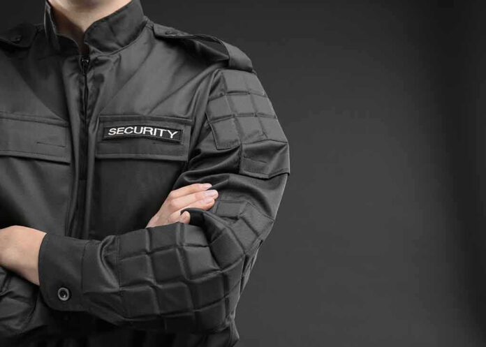 shutterstock_1106036012 security guard in black uniform with crossed arms