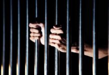 Green Beret Child-Assault Conviction Stuns Army hands gripping prison bars