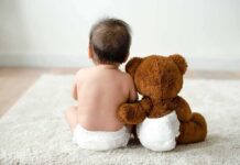 HHS Pushes $29M Blitz – Taxpayer Cash Floods Diaper Program Baby in diaper sitting with teddy bear