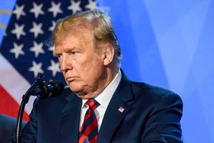 man at podium speaking into microphone