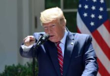 CFTC Smacks Insider Bets On Trump Words speaker at podium pointing during outdoor press event