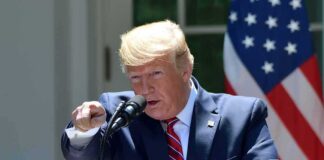 speaker at podium pointing during outdoor press event