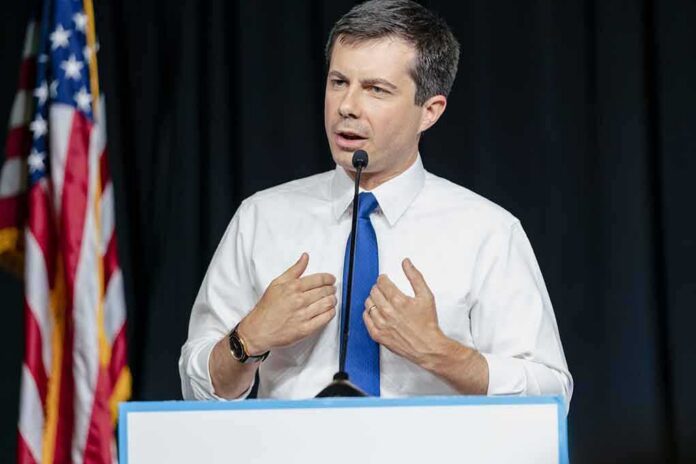 man in white shirt and blue tie speaking at a podium