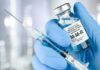 Rubella Twist: Fetal-Derived Line Exposed Gloved hands holding a vaccine vial and syringe