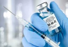 Rubella Twist: Fetal-Derived Line Exposed Gloved hands holding a vaccine vial and syringe