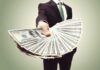 Businessperson holding a fan of US dollar bills