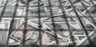 pile of us dollar bills with a ten-dollar note on top