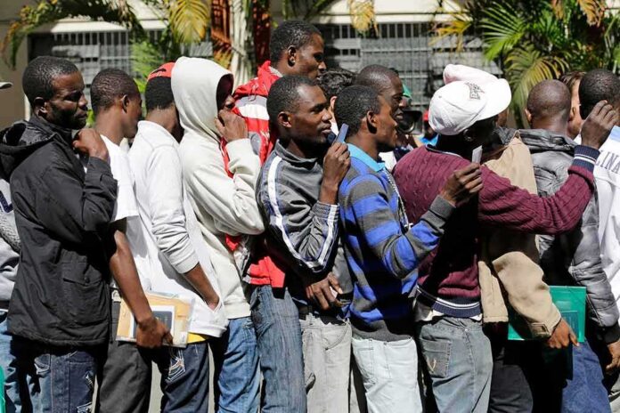 shutterstock_1635369601 Group of men standing in a line outdoors