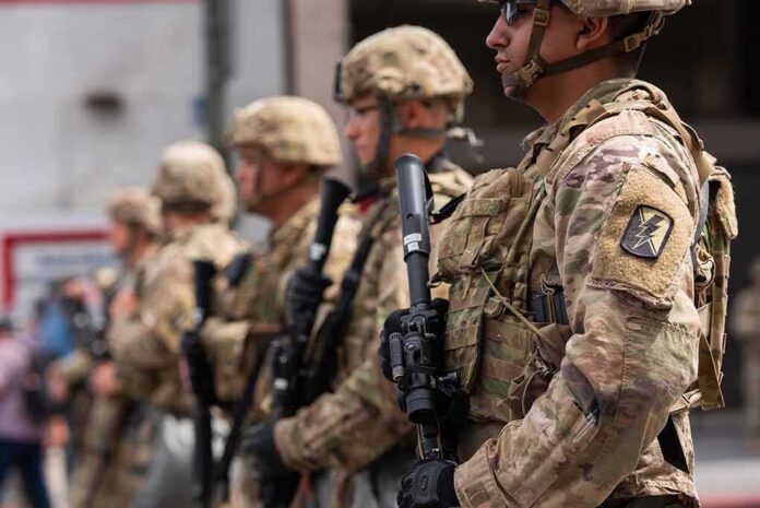 Soldiers in camouflage gear stand in formation holding rifles