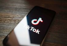 On-Camera Chaos Near Amsterdam Centraal Smartphone displaying TikTok app logo on screen
