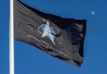 Russia Cries NUKES — X-37B Under Fire United States Space Force flag waving against a blue sky