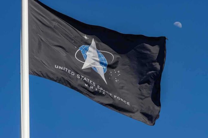 shutterstock_1921117997 United States Space Force flag waving against a blue sky