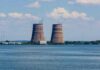 Drone Chaos at Europe’s Biggest Reactor Cooling towers of a power plant by a wide river