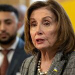 woman speaking at event with blurred attendees behind