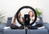 smartphone on ring light filming two people on a couch