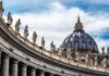 Communist Grip Alleged — Bishops Caught In Middle St. Peter's Basilica dome with statues along colonnade
