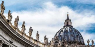 St. Peter's Basilica dome with statues along colonnade