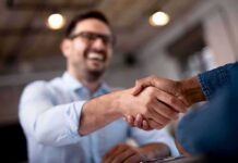 Two people shaking hands in an office