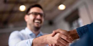 Two people shaking hands in an office