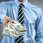 Donation Deluge – Refund Avalanche Slams Talarico Person in business attire offering bundles of US dollar bills