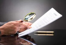 Records Faked After Audit — Taxpayers Exposed Hands holding magnifying glass over contract document