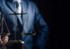 Unanimous Hit: Billionaire Stonewall Backfires Scales of justice held by a person in a suit