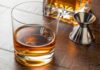 Tariff Gone – Whiskey Math Changes Overnight Whiskey in a rocks glass on a wooden table
