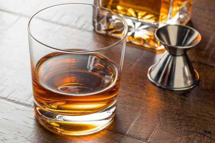 Whiskey in a rocks glass on a wooden table
