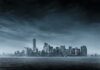 city skyline across water under overcast sky