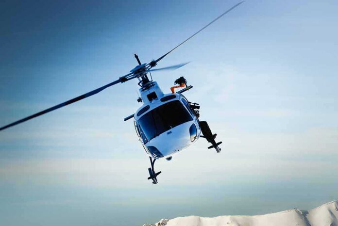shutterstock_116155468-1 helicopter banking over snowy mountains