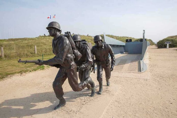 Soldier statues disembarking from a landing craft on a sandy beach