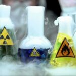 6,000-Meter Mud Upsets Rare-Earth Game laboratory flasks with hazard symbols and colorful liquids