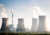 Cooling towers emitting steam at an industrial power plant