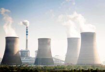Beijing’s 2030 Nuclear Play Changes Everything Cooling towers emitting steam at an industrial power plant