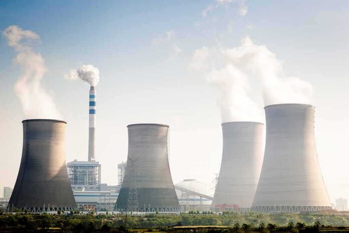 Cooling towers emitting steam at an industrial power plant
