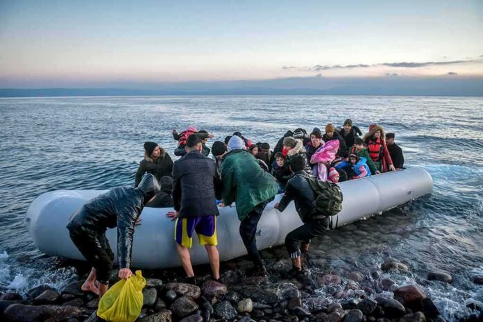 Group of people arriving on a crowded inflatable boat at a rocky shore