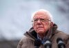 Nationwide AI Freeze? Bernie’s Crackdown Goes Nuclear elderly man in glasses speaking outdoors into microphones