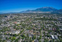 Aerial view of a city with neighborhoods and mountains in the background
