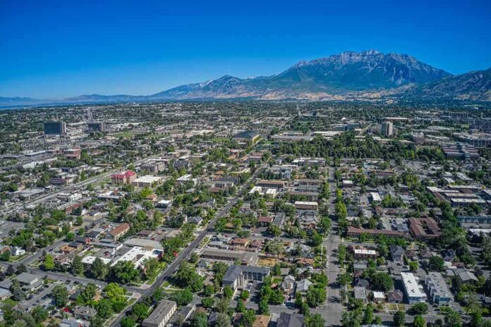 shutterstock_1778924834 Aerial view of a city with neighborhoods and mountains in the background