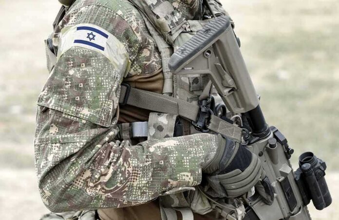 shutterstock_1917131027 soldier in camouflage holding a rifle