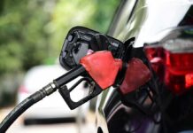 Wallets Squeal – Trump Defends Price Spike Fuel nozzle inserted into a car's gas tank