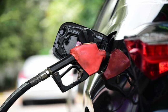 shutterstock_1933784621 Fuel nozzle inserted into a car's gas tank