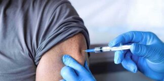 Healthcare worker giving an arm injection