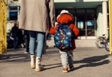 Shocking Paris Nursery Allegations – Catholic School Scandal Widens Child with backpack walking to school with adult