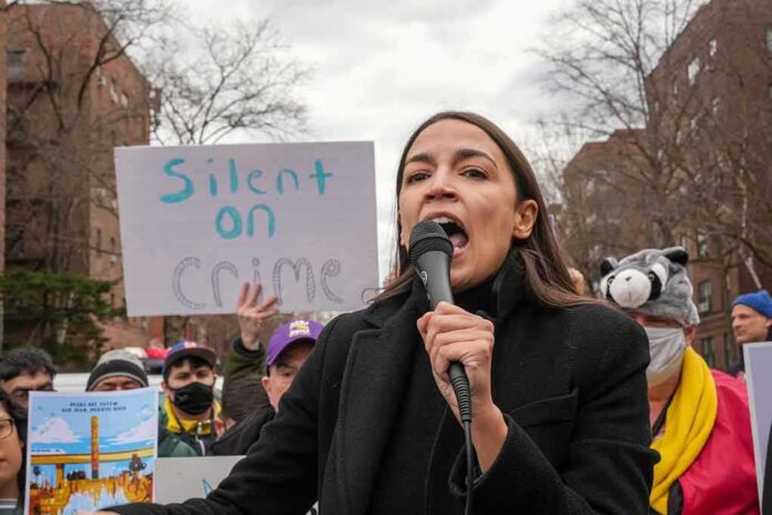 woman speaking into a microphone at an outdoor protest