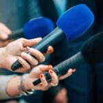 War, Gas, Borders—One Risky Broadcast Reporters holding colorful microphones