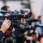 Google’s $17B Gambit: Data Center Dollars Erase Homestead Bills? Video cameras on tripods at a media event