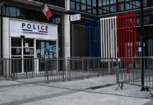 Police station entrance with barriers and French flag colors