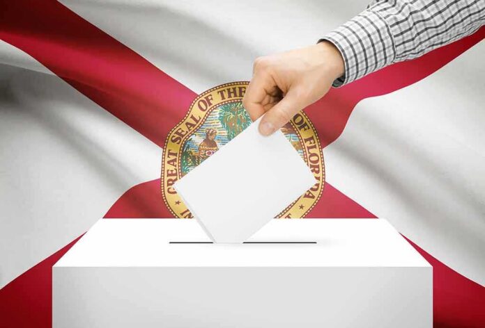 shutterstock_233414914 Hand casting a ballot in front of the Florida state flag