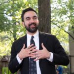 Bin Laden Message? NYC Sparks Outrage Man in suit speaking with hands on chest outdoors